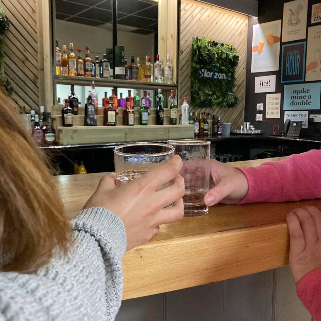 Events at Horizon - a person holding glasses of liquid