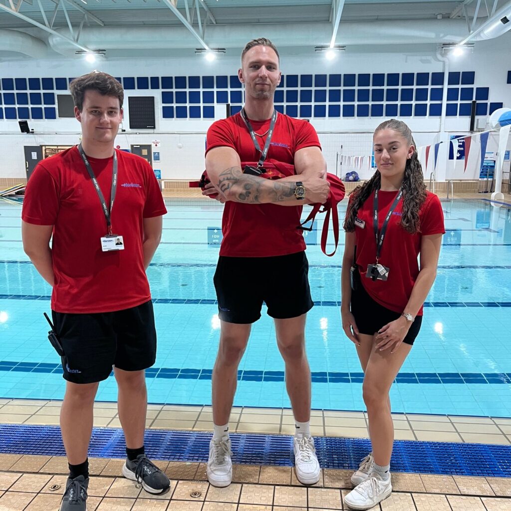 a group of lifeguards standing in a pool