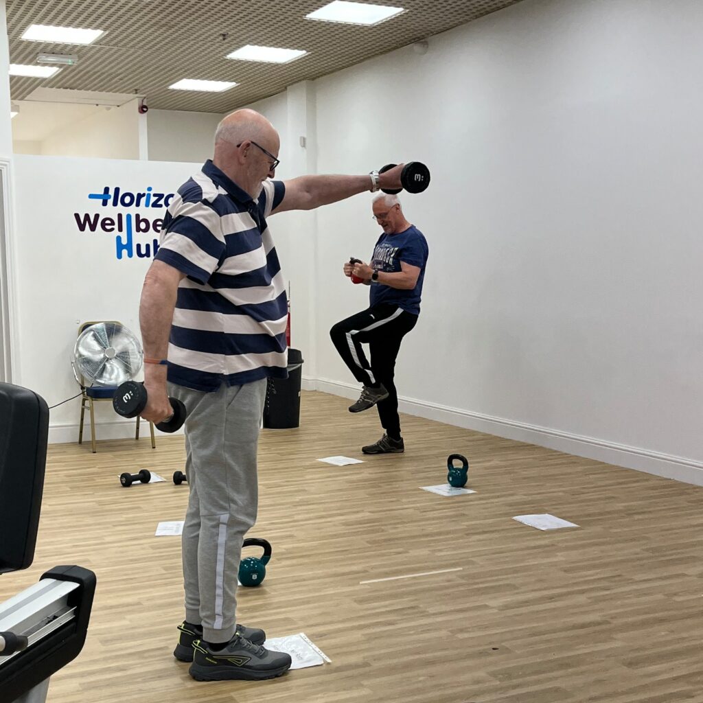 a man lifting weights in the Wellbeing Hub mens circuit class