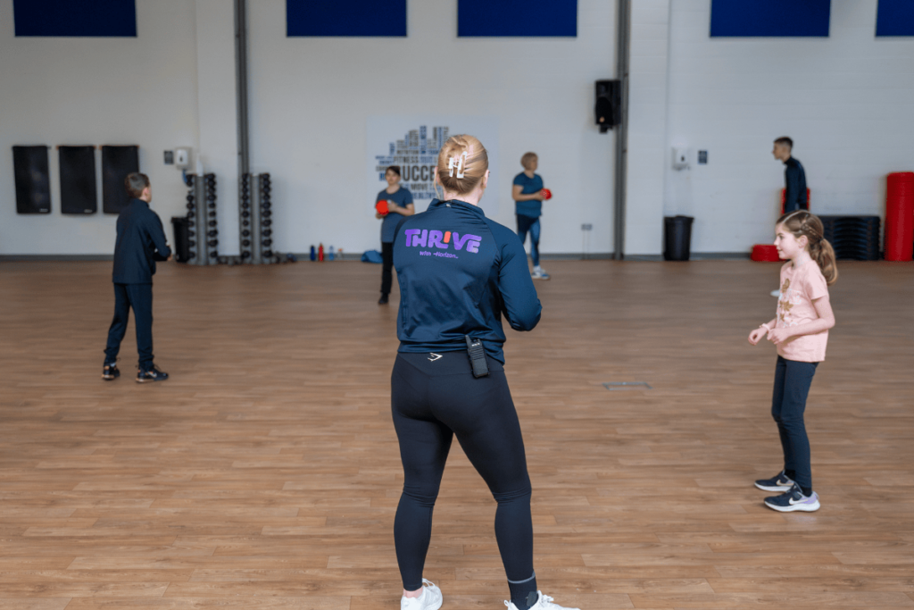 Instructor leading a THRIVE dodgeball class.