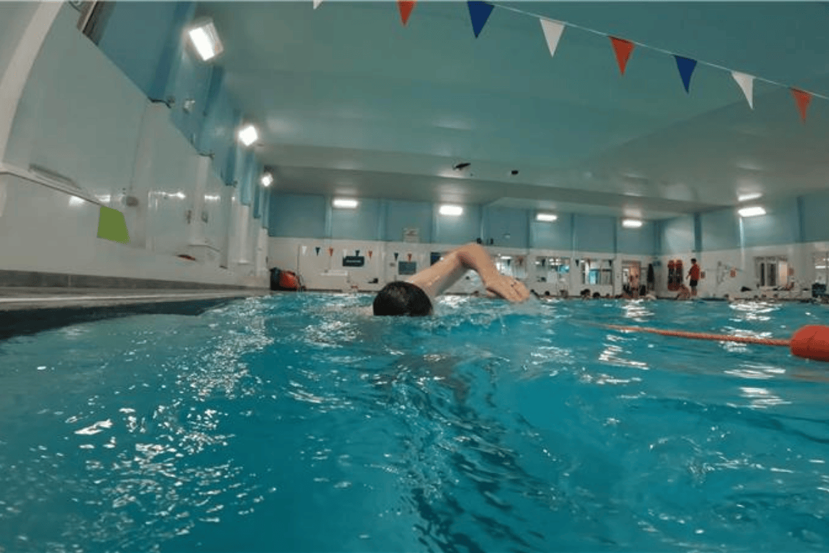 A man swimming in one of our adult swimming lessons
