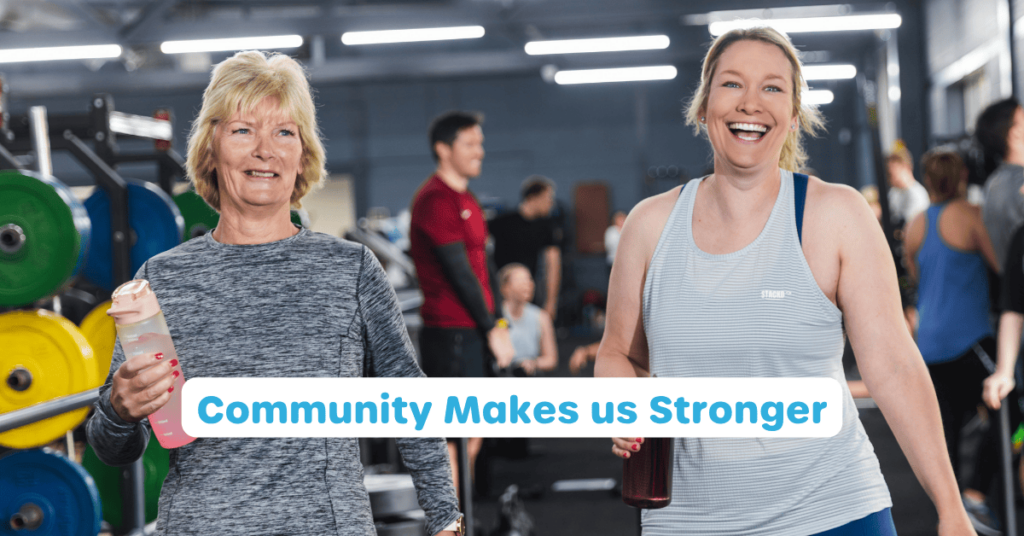 Two people looking happy in a HYROX class with the writing 'Community Makes us Stronger' in front.