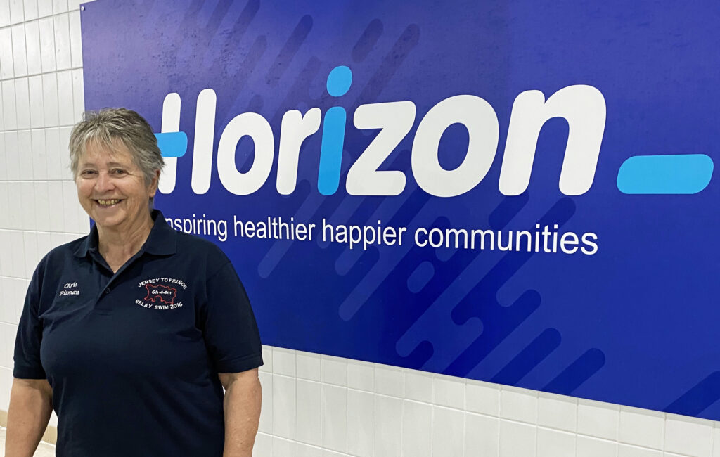 Photo of Chris next to the Horizon sign at Waterlooville Leisure Centre.
