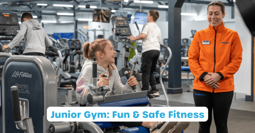 Photo of a junior gym session with a gym instructor supervising a junior member on the leg curl machine. The words 'Junior Gym: Fun & Safe Fitness' are written in front.