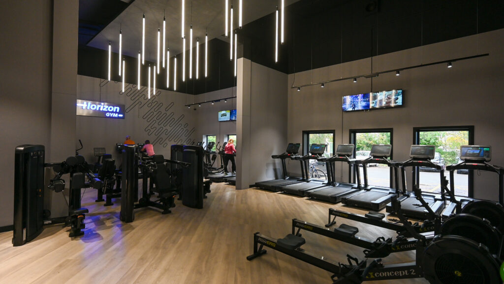 Modern gym with exercise equipment and lighting