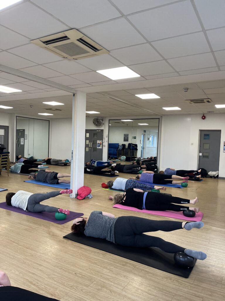 Participants engaged in a Pilates class.