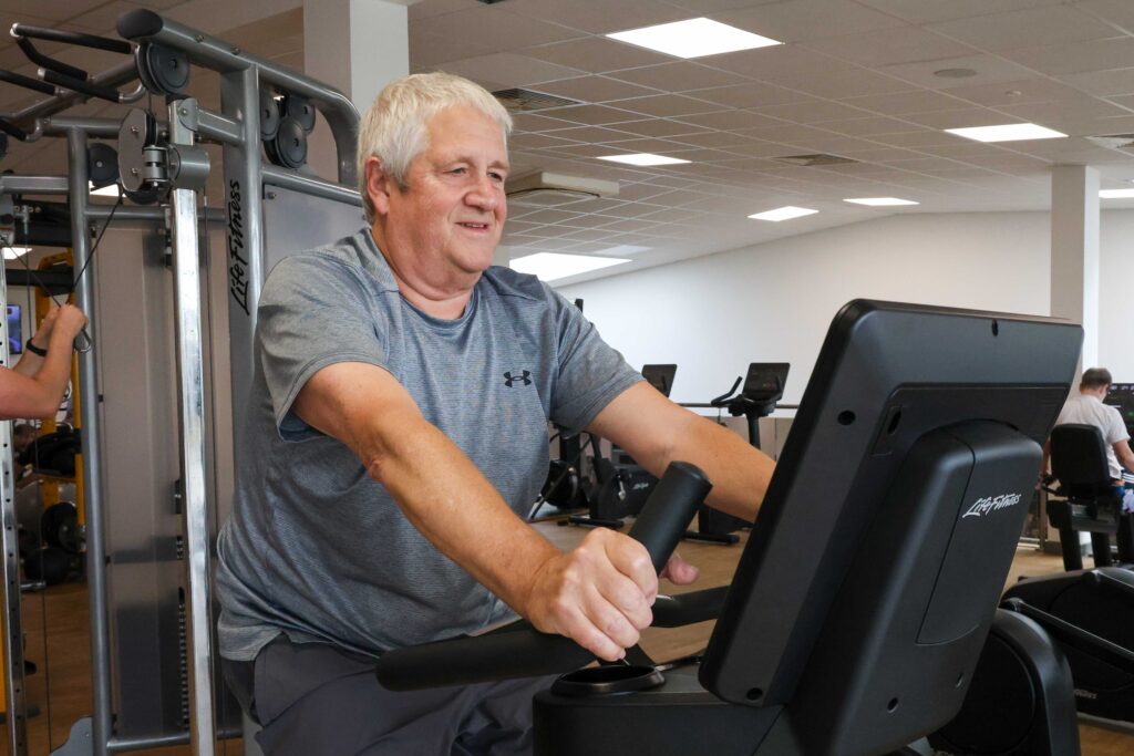 Man exercising on stationary bike indoors gym in Havant and Waterlooville