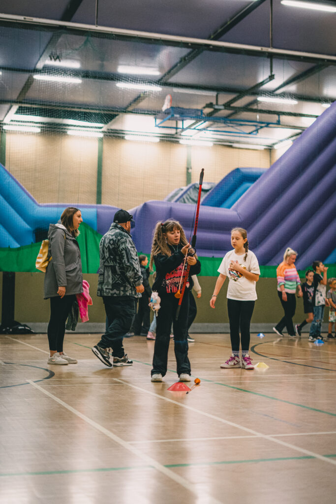 Children playing in a sports hall.