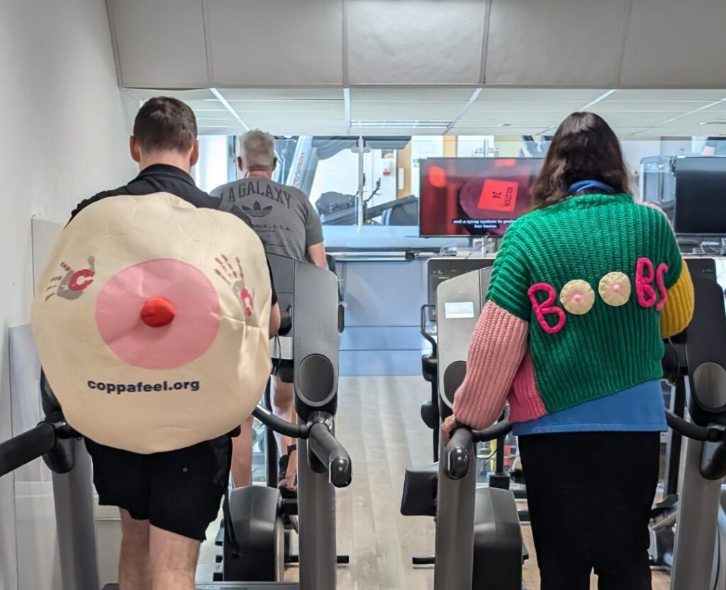 People exercising in awareness-themed outfits.