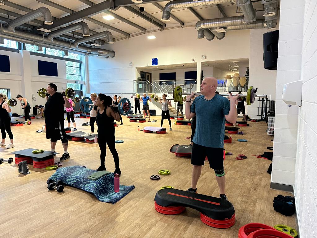 Group fitness class with weights.