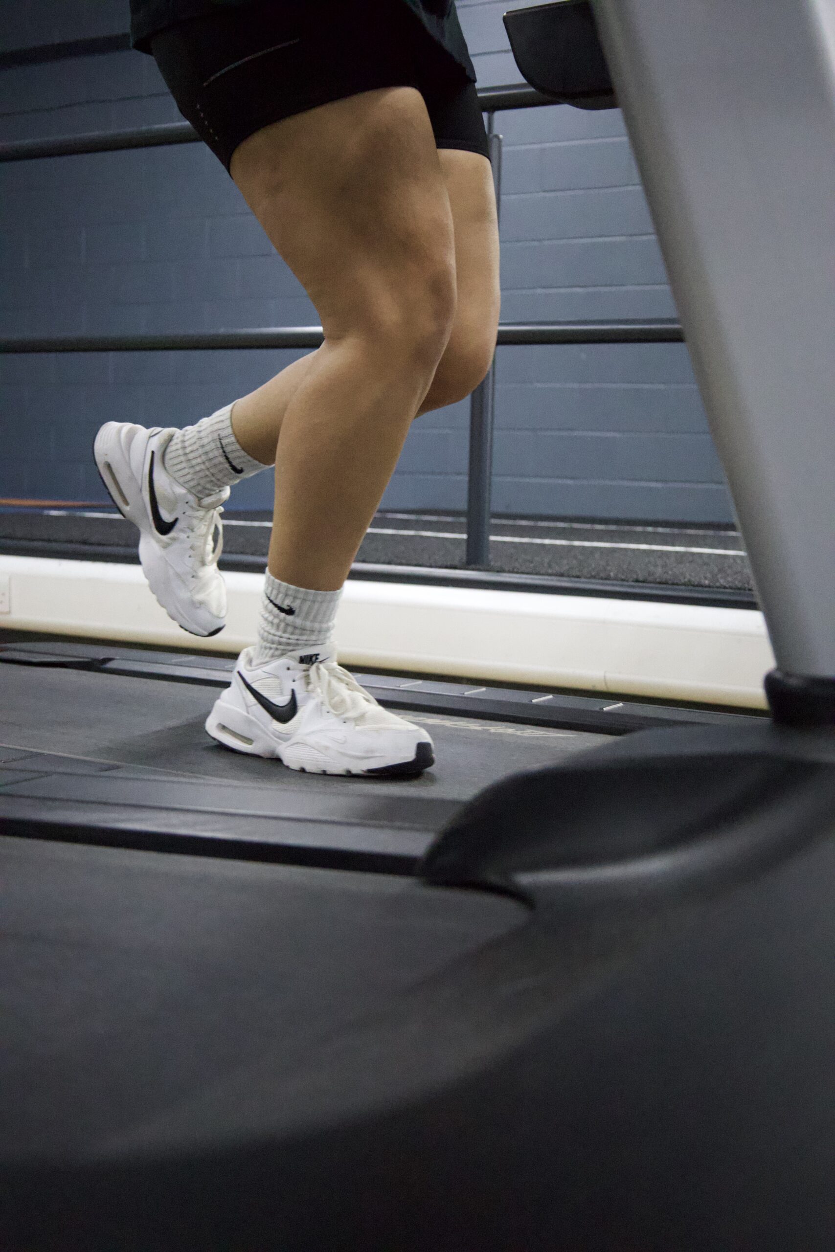 Person running on treadmill, close-up.