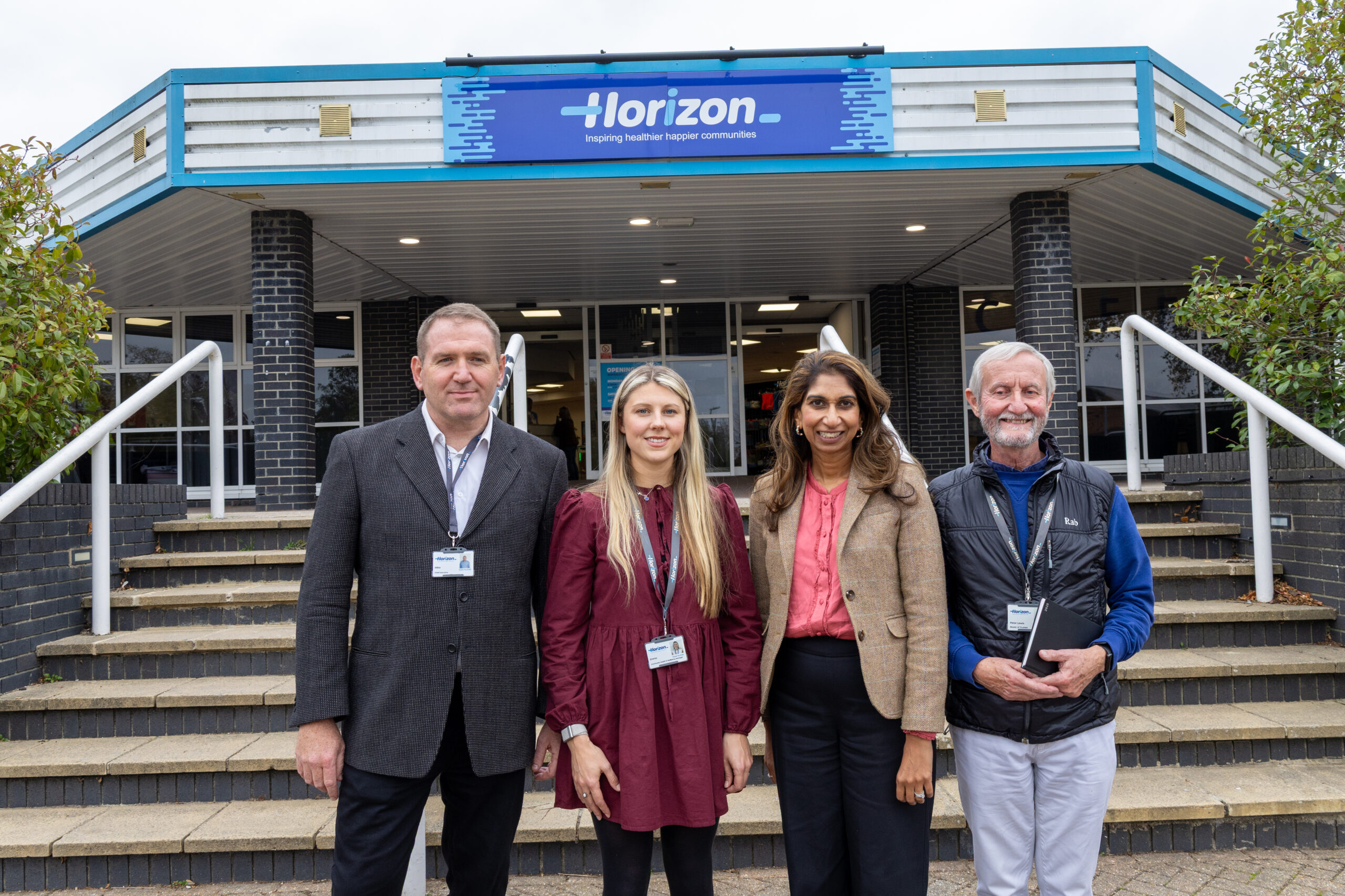 Group photo outside Horizon building entrance suella braverman.