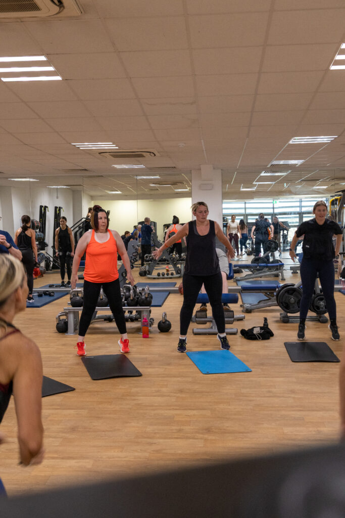 Group exercising in a gym studio.