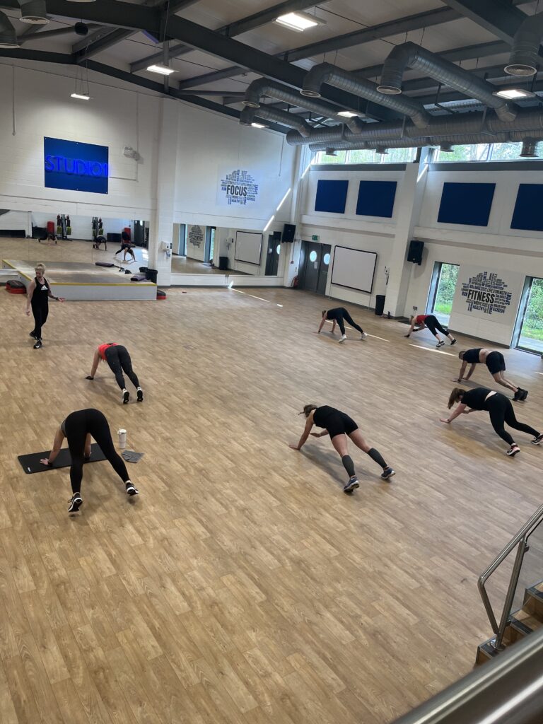 Group fitness class in spacious studio.
