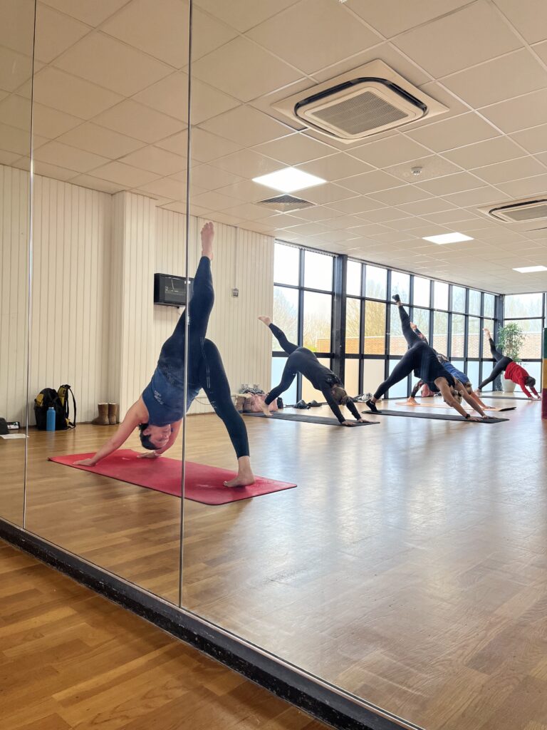 Yoga class with mirrored reflection