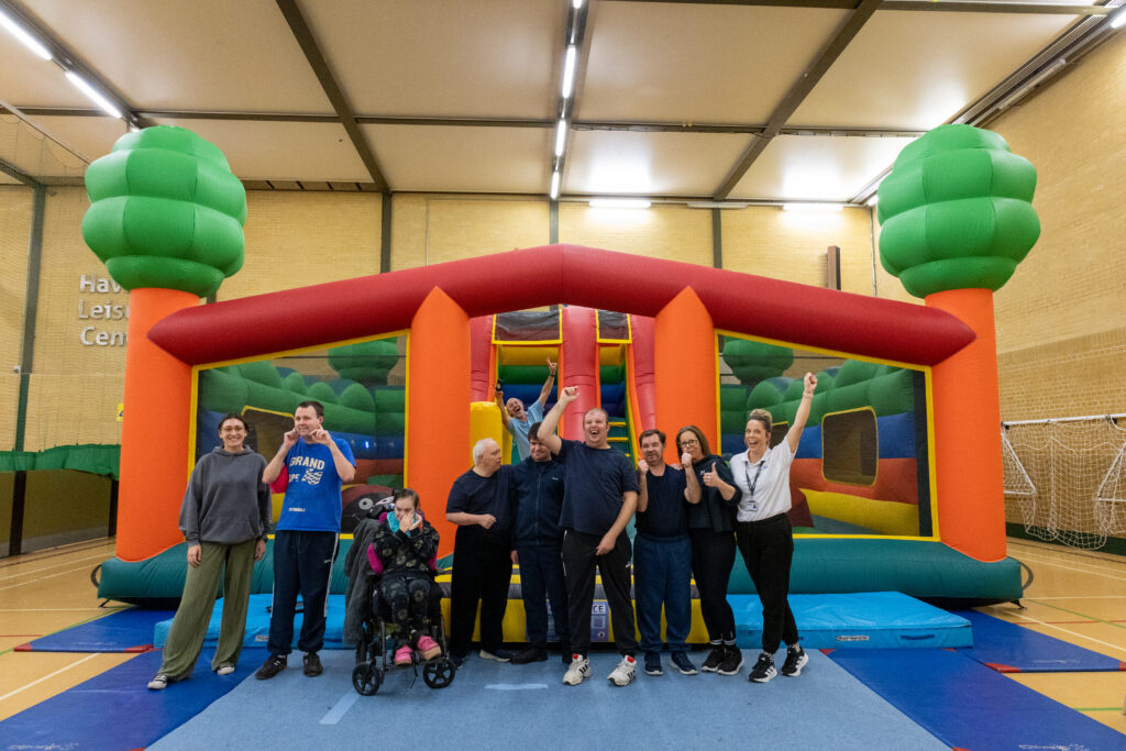 Group celebrating near inflatable play structure horizon SEND sessions