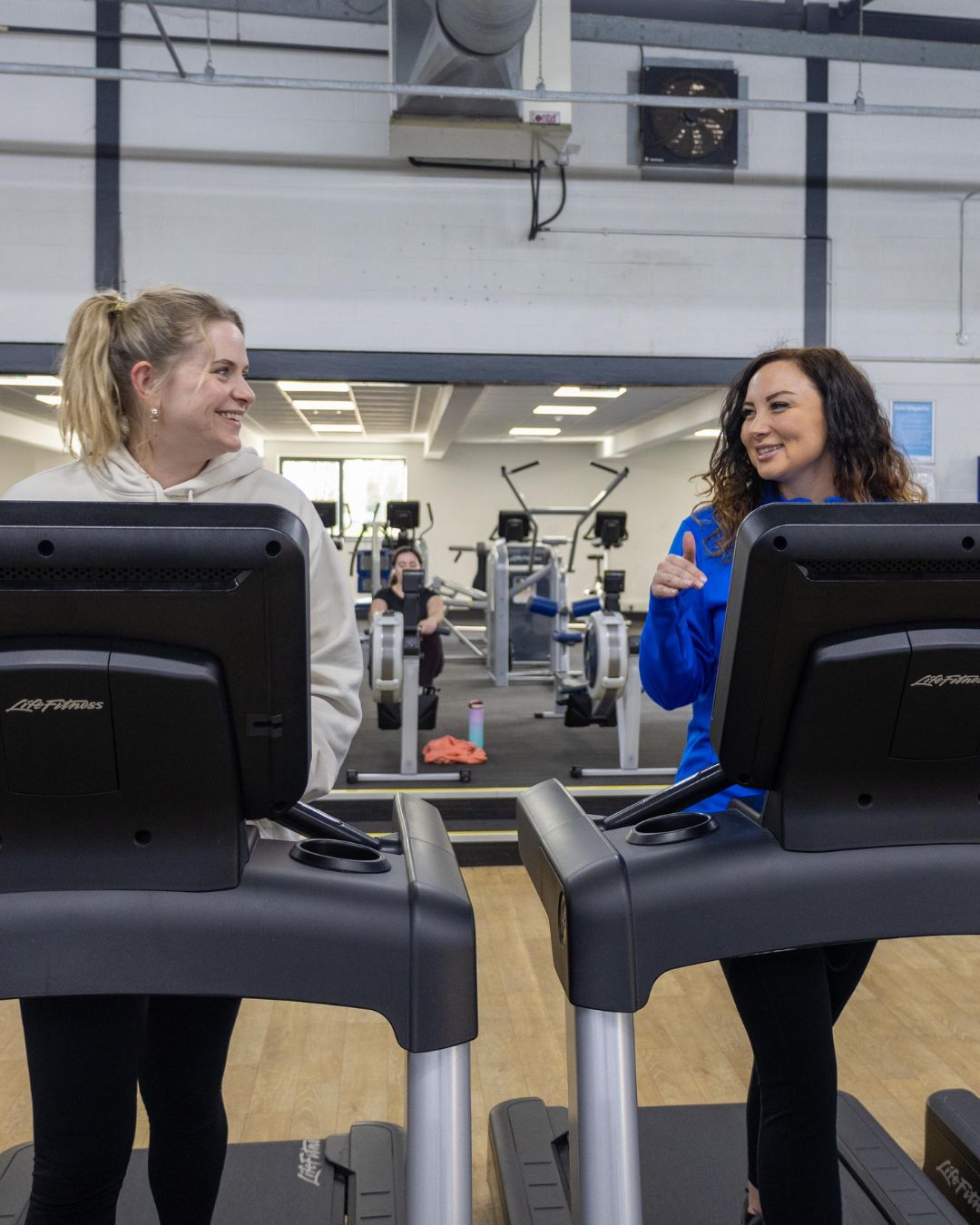 Two women exercising on treadmills. for a stress free christmas