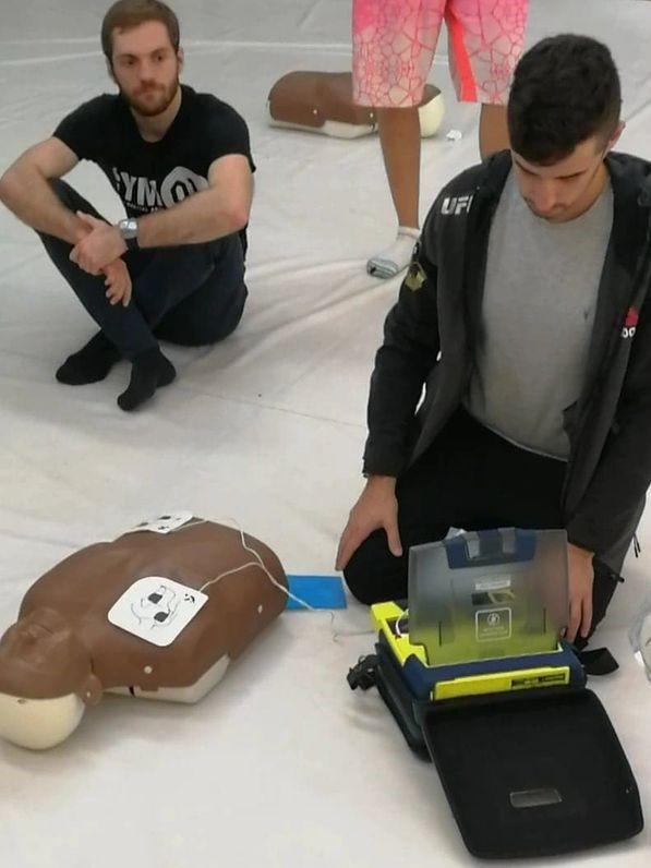 CPR training with manikins and equipment.