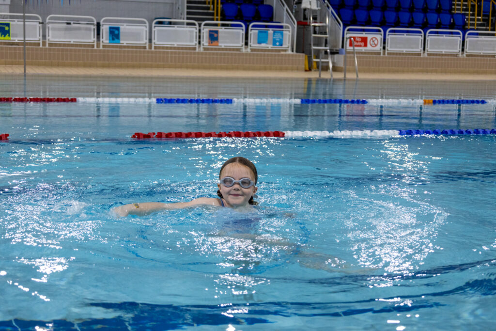 Child learning to swim confidently at Swim School at Horizon