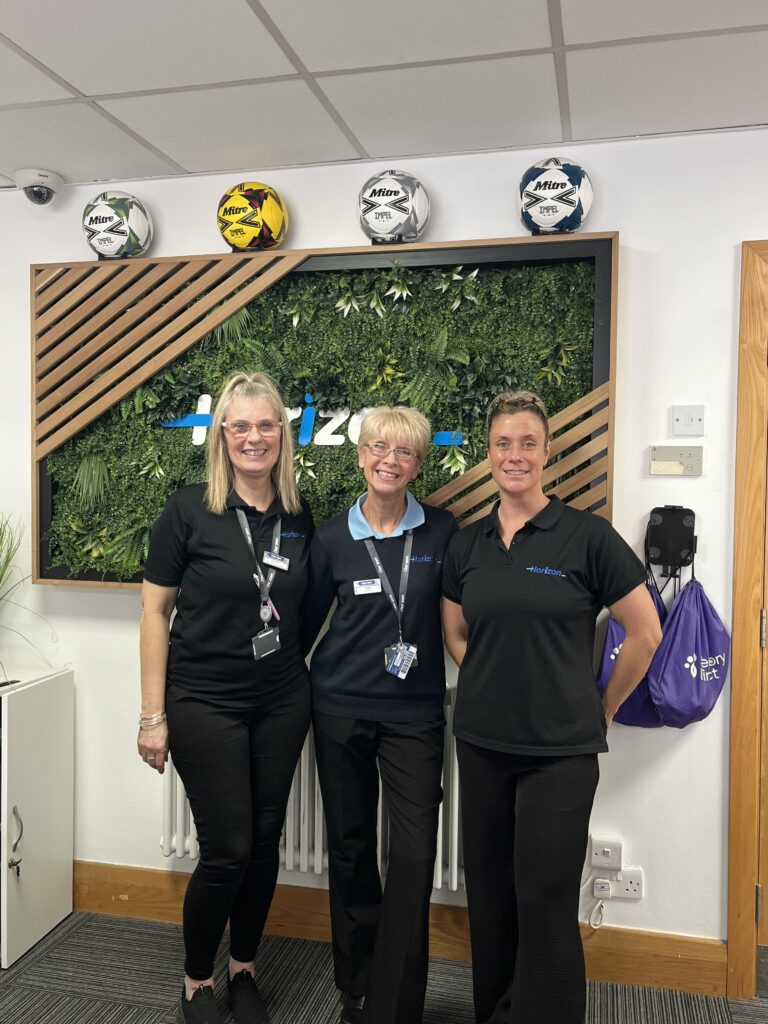 Three staff members at reception in our Centres