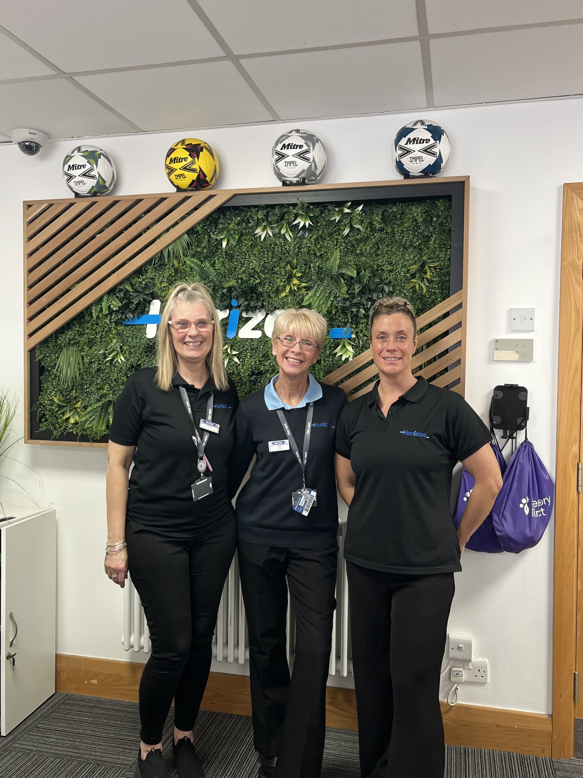 Three staff members at reception in our Centres